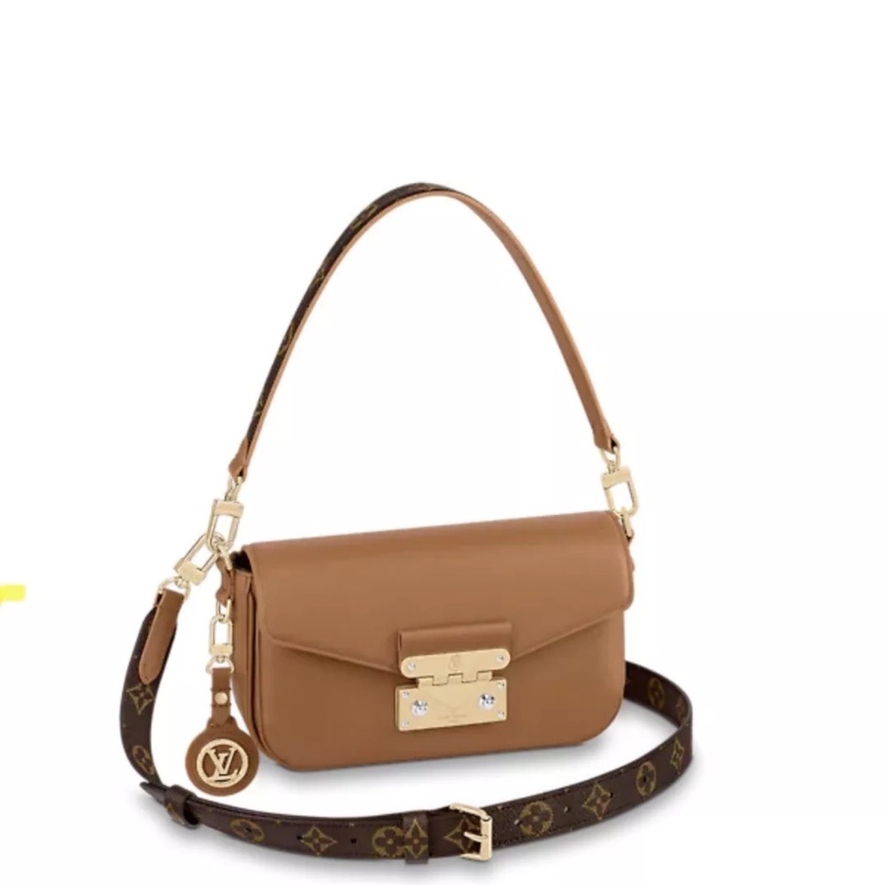 SOLD.    Louis Vuitton Swing shoulder/handbag with charm